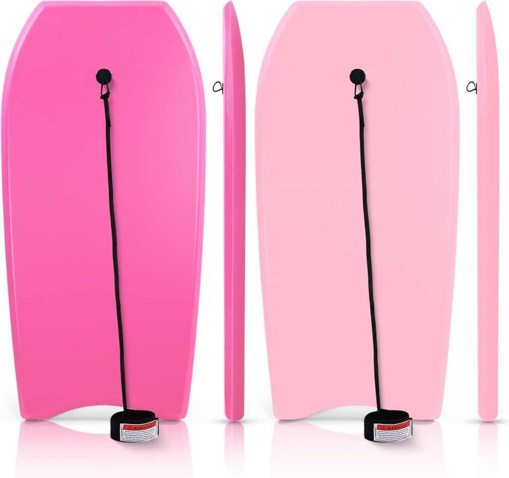 This image features two pink bodyboards, one with a more rounded design and the other with a sleeker profile, both equipped with safety leashes for added security.